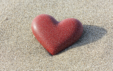 Heart-shaped stone on a textured background, symbolizing love and connection.