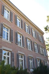 Classic Brick Building Exterior with Gray Shutters and Windows
