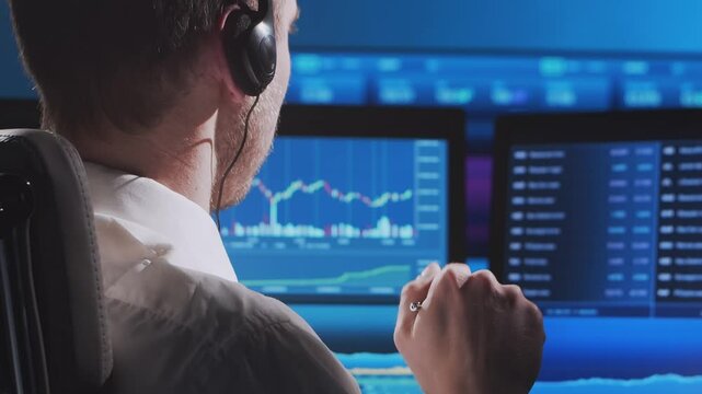 Trader works in office using workstation and analysis technology. Workplace of professional crypto exchange broker. Close-up portrait. Global financial markets, business strategy, currency exchange