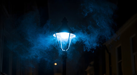 Mysterious Streetlamp Emitting Blue Vapour Amidst The Darkness Of The Night
