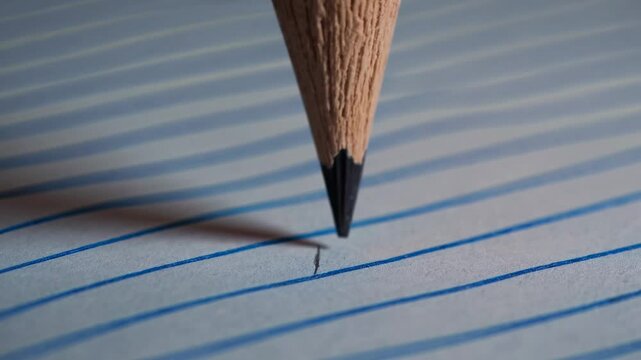 Pencil drawing lines on bluelined paper with smooth motion in ultra hd