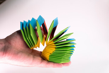 Toy paper rainbow on white background, color spiral for play. paper spring. paper crafts. toy...
