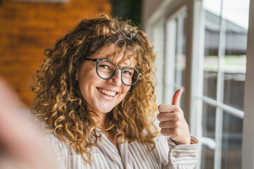 Adult caucasian woman take a self portrait and thumb up fun and smile