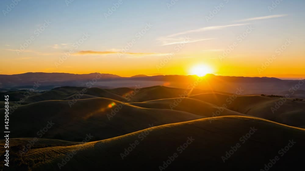 Poster fog rolling across a valley with sunbeams breaking through.
