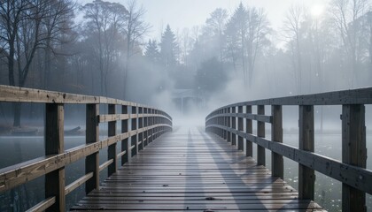 Naklejka premium Serene Misty Morning Over a Wooden Bridge in a Tranquil Forest