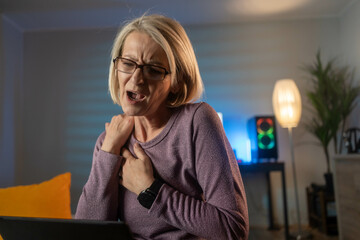 Senior woman, neck pain and stress in living room home of spine injury, fibromyalgia and osteoporosis. Sick, tired and fatigue lady in orthopedic, arthritis and health problem stretching body muscle