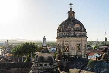 Colonial church dome and statue at sunrise in Granada, Nicaragua