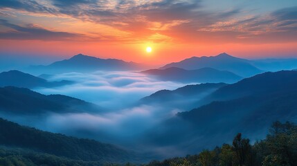 The soft, warm light of a sunrise over a misty mountain landscape