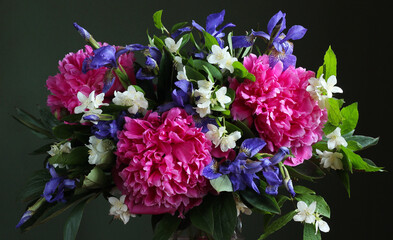 Bouquet of peonies, irises and jasmine flowers creating a colorful floral arrangement