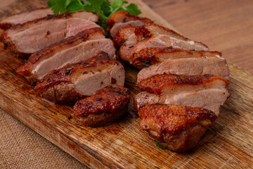 Roast duck breast, sliced, on a wooden chopping board,close-up, no people,