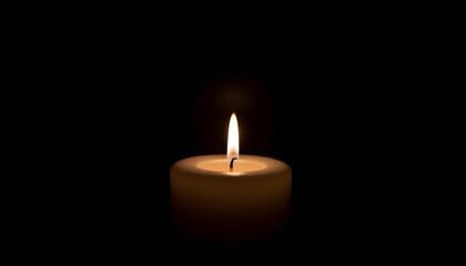 Candle burning in darkness