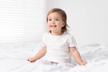 Fototapeta premium Cute little baby girl on bed at home