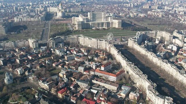 Aerial drone view over Bucharest downtown cityscape, Romania. Palace of Parliament, National Salvation Cathedral, The Patriarchal Cathedral and Boulevard Unirii.