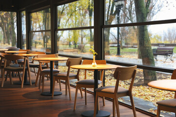Stylish restaurant with large windows and comfortable furniture. Interior design