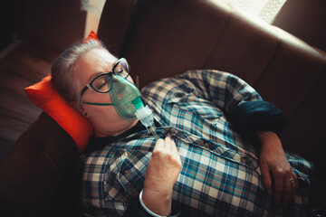 Asthma therapy – woman holding inhaler during breathing difficulty
