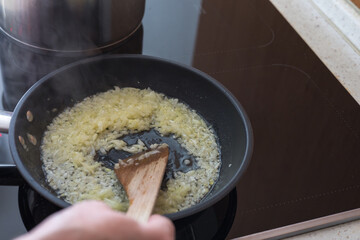 Boiled cabbage and fried onion in a pan