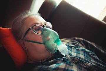Asthma therapy – woman holding inhaler during breathing difficulty