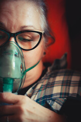 Asthma therapy – woman holding inhaler during breathing difficulty