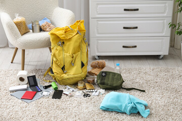 Survival kit. Different emergency supplies on floor indoors