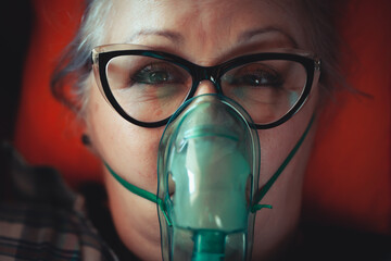 Asthma therapy – woman holding inhaler during breathing difficulty