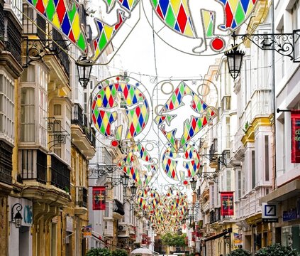 Colorful decorations hang over the streets during the Carnival de Cadiz.