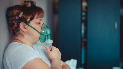 Asthma therapy – woman holding inhaler during breathing difficulty
