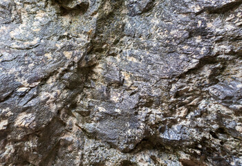 the walls of a stone gorge in a mountainous area, the structure of a geological section