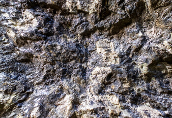 the walls of a stone gorge in a mountainous area, the structure of a geological section