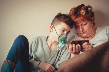 Young Boy Managing Asthma with Inhaler and Oxygen Support with his mother
