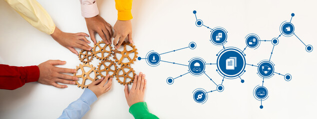 Obraz premium This image showcases a collaborative management approach with hands assembling gears, representing teamwork and digital connectivity in modern business operations. Amity