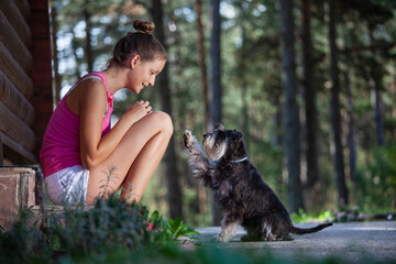 Obraz premium Girls and dogs having fun in nature
