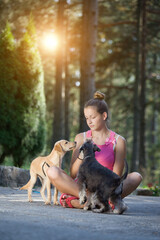 Obraz premium Girls and dogs having fun in nature