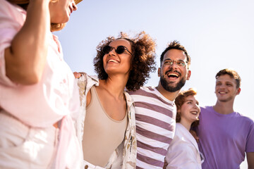 Group of young friends walking on the beach
