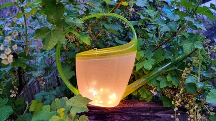 watering can with lights in the night