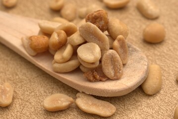 Peanuts, granola, and roasted nuts on neutral background – healthy snack and protein source