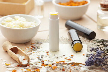 Diy lip balms, emulsifier in a wooden spoon with cosmetic ingredients and shea butter in a bowl