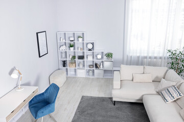 Comfortable sofa, shelving unit, table and armchair in living room, above view