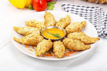 Fried stuffed momo dumplings with sauce