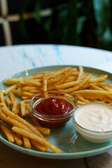 Delicious fries served with rich sauces at a trendy dining spot