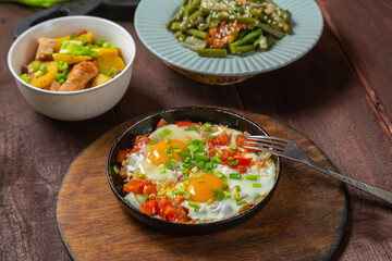 Set table, Jewish food, tzimmes, chelnt, shakshuka and couscous