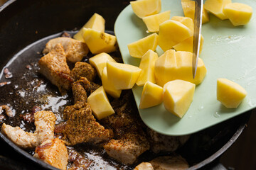 The prepared potatoes are poured into a frying pan
