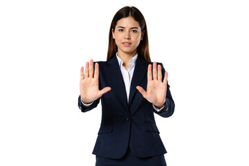 Serious young businesswoman dressed in a formal dark blue suit and white shirt, decisively holding up both hands with open palms facing forward in a universal 'stop', 'halt', or number 'ten' gesture