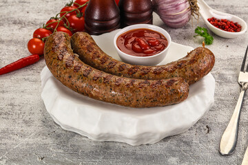 Grilled beef sausages with sauce