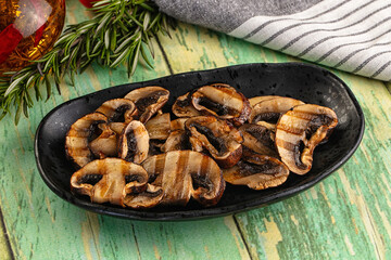 Tasty hot grilled champignon mushrooms
