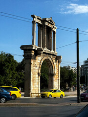 The ruins of Hadrian's triumphal arch in Athens near the road	