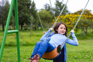 girl-playing-on-the-swing-at-the-park