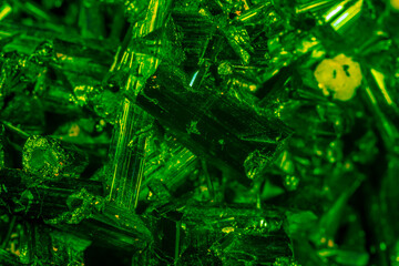 Green crystal mineral stone. Gems. Mineral crystals in the natural environment. Texture of precious and semiprecious stones. Seamless background with copy space colored shiny surface of precious stone