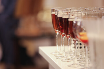 Wine glasses filled with red wine on a counter