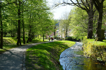 Bad Schandau, spa park in spring with tourists and the Kirnitzsch river