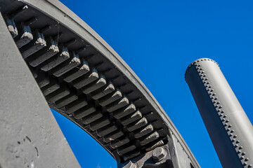 Detailed view of interlocking gears working together in a mechanical system during daylight